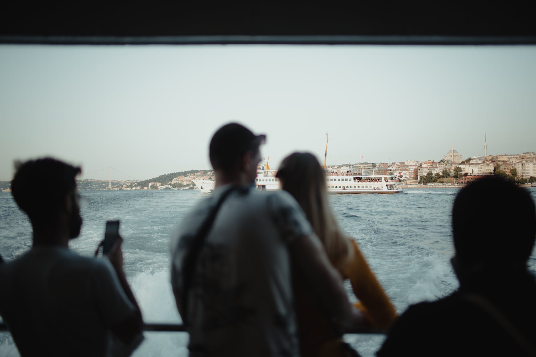 passengers watching harbour from cruise ship