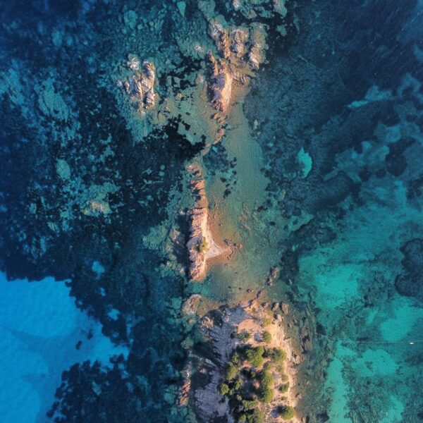 drone shot of a tropical island among turquoise water