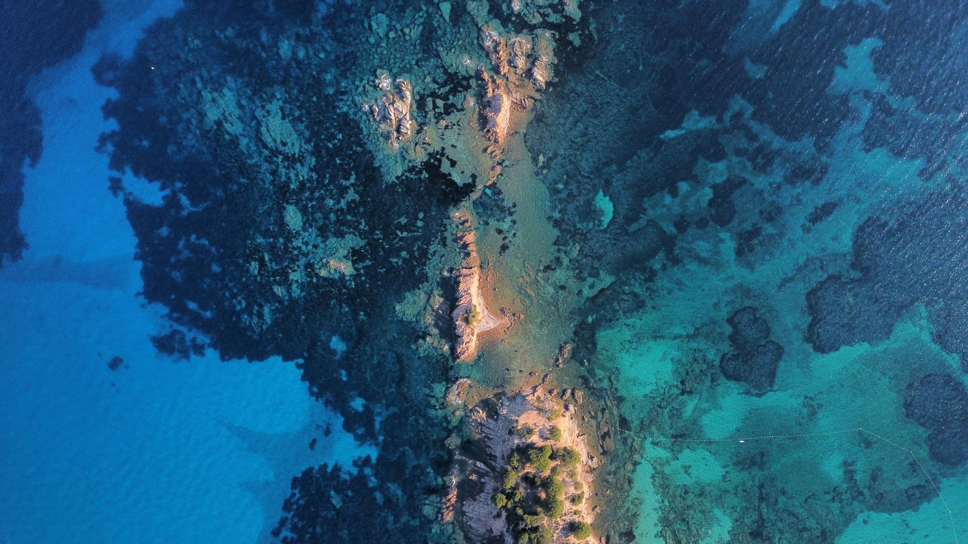 drone shot of a tropical island among turquoise water