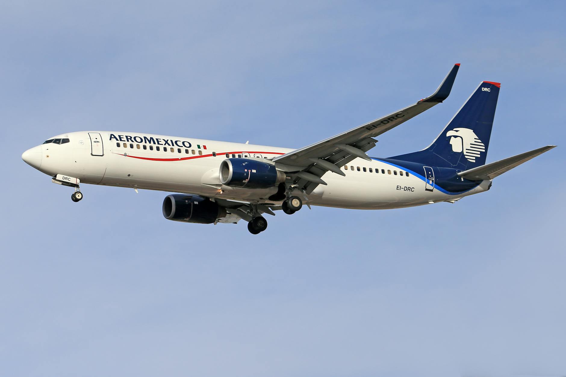 a white and blue airplane flying in the sky